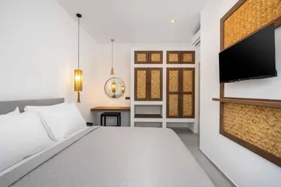 a bedroom with a bed and a flat screen tv at Villa Kiotari Sky in Kiotari