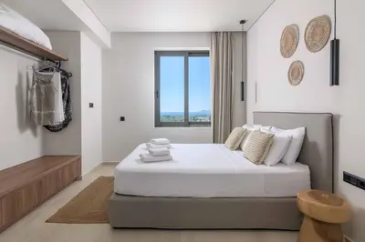 a bedroom with a large white bed with a window at Massari Hills Villa 8 in Malona Village