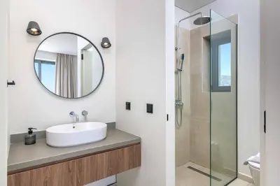 a bathroom with a sink and a mirror at Massari Hills Villa 8 in Malona Village