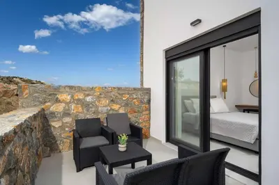a room with a bedroom and a bed and a balcony at Villa Kiotari Sun in Kiotari