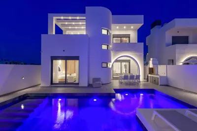 a villa with a swimming pool at night at Villa Filia in Ialyssos