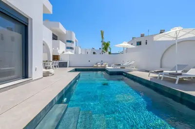 a swimming pool in the backyard of a house at Villa Filia in Ialyssos