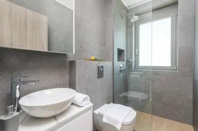 a bathroom with a sink and a glass shower at Villa Panaxia Keema in Theologos