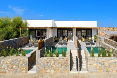 a resort with a swimming pool and a building at Villa Kiotari Star in Kiotari