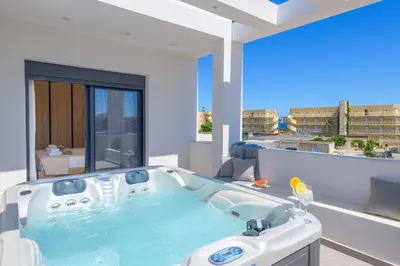 a large bath tub in a room with a balcony at Villa Evelia in Ialyssos