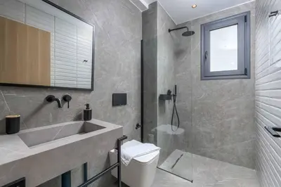 a bathroom with a sink and a toilet and a shower at Villa Evelia in Ialyssos