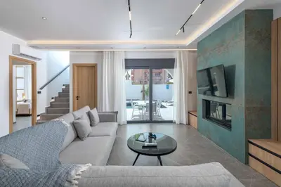 a living room with a couch and a tv at Villa Evelia in Ialyssos