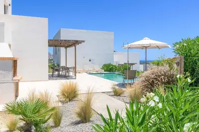 a villa with a swimming pool and an umbrella at Massari Hills Villa 9 in Malona Village