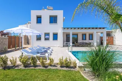 a villa with a swimming pool and a house at Villa Panaxia Akte in Theologos