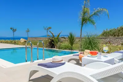 a villa with a pool and a table and chairs at Villa Panaxia Akte in Theologos