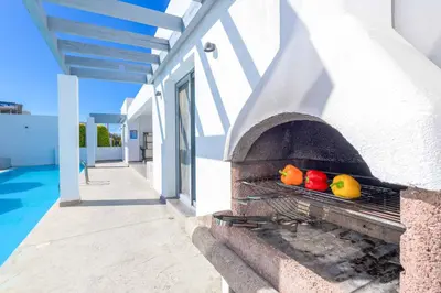 a stone oven with fruit on the side of a building at Villa Pefko in Gennadi