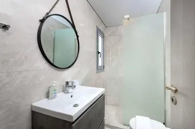 a bathroom with a sink and a mirror at Villa Pefko in Gennadi