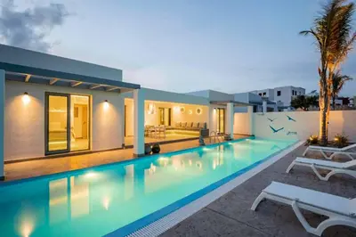 a swimming pool in front of a house at Villa Damaskina in Gennadi