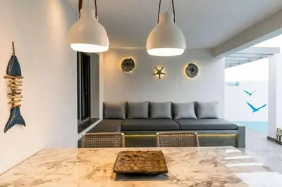 a living room with a couch and a table at Villa Damaskina in Gennadi