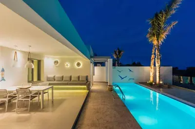 a villa with a swimming pool at night at Villa Damaskina in Gennadi