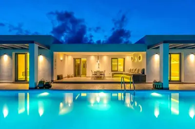 a house with a swimming pool at night at Villa Damaskina in Gennadi