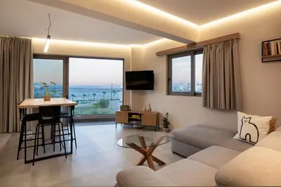 a living room with a couch and a table at 400 Steps Apartment in Rhodes Town