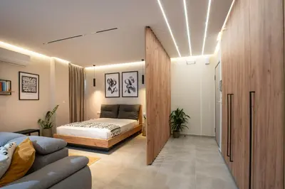 a bedroom with a bed and a couch in a room at 400 Steps Apartment in Rhodes Town