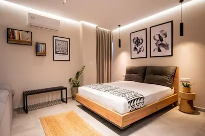 a bedroom with a bed and some pictures on the wall at 400 Steps Apartment in Rhodes Town