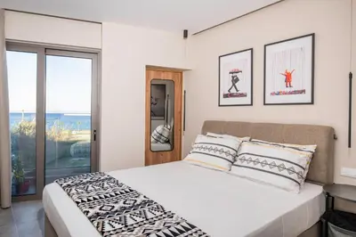 a bedroom with a bed and a large window at 400 Steps Apartment in Rhodes Town