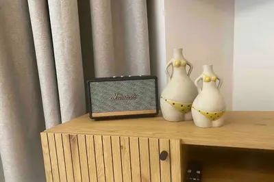 three white vases sitting on a shelf with a radio at 400 Steps Apartment in Rhodes Town