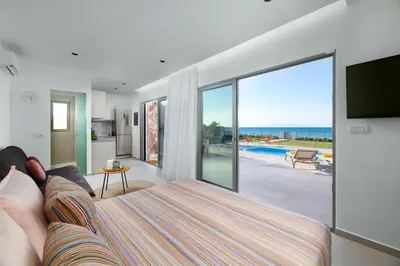 a living room with a couch and a view of the ocean at KYRA beachfront house in Theologos Rhodes in Theologos