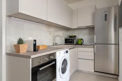 a kitchen with a washer and a sink and a dishwasher at KYRA beachfront house in Theologos Rhodes in Theologos