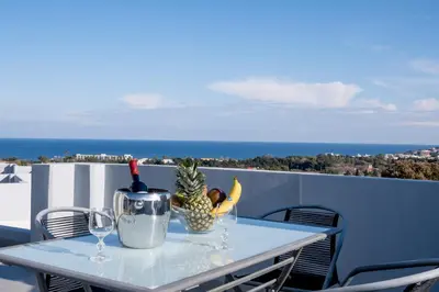 a table with a pineapple on top of a balcony at E&A luxury apartment with sea view in Rhodes Town
