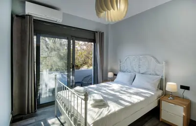 a bedroom with a bed and a large window at E&A luxury apartment with sea view in Rhodes Town