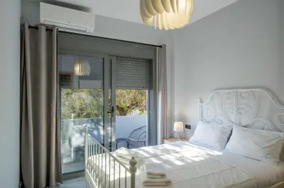 a bedroom with a bed and a large window at E&A luxury apartment with sea view in Rhodes Town