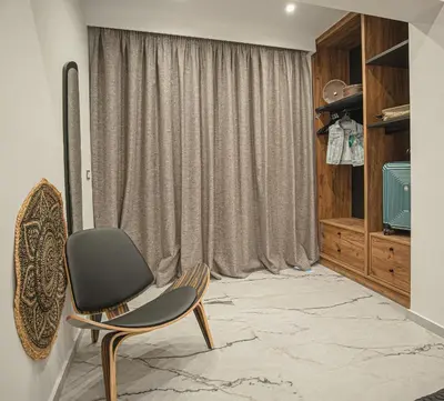 a chair in a room with a window at Lofos Inn Villa Luxury in Kalithies