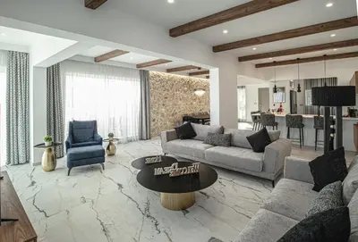 a living room with a couch and a table at Lofos Inn Villa Luxury in Kalithies