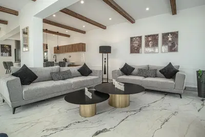 a living room with two couches and two tables at Lofos Inn Villa Luxury in Kalithies