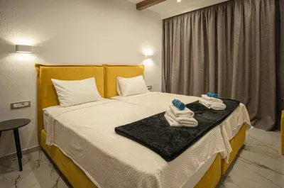 a hotel room with a bed with towels on it at Lofos Inn Villa Luxury in Kalithies