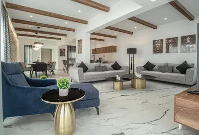 a living room with blue couches and a table at Lofos Inn Villa Luxury in Kalithies