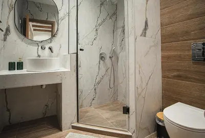 a bathroom with a shower with a sink and a toilet at Lofos Inn Villa Luxury in Kalithies
