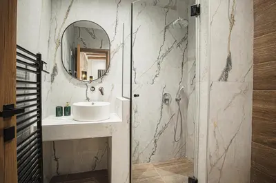 a bathroom with a sink and a mirror at Lofos Inn Villa Luxury in Kalithies