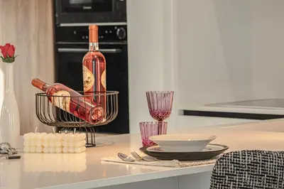 a bottle of wine in a basket on a kitchen counter at Lofos Inn Villa Luxury in Kalithies