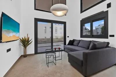 a living room with a couch and a table at San Marino Luxury Suites #3 in Asgourou