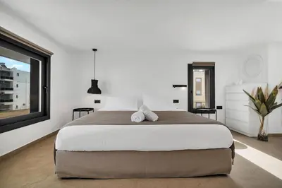 a bedroom with a large bed with two teddy bears on it at San Marino Luxury Suites #3 in Asgourou