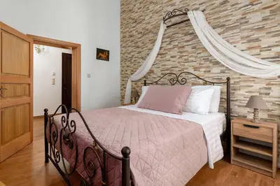 a bedroom with a bed and a brick wall at Casa Medievale in Rhodes Town