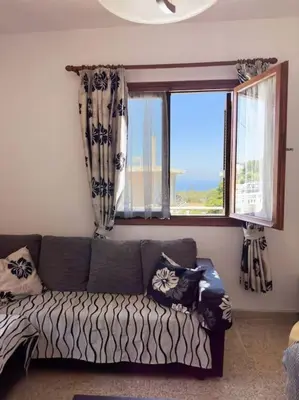 a living room with a couch and a window at Maison authentique avec grande terrasse in Kritinía