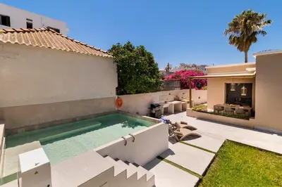 a swimming pool in the backyard of a house at Lefka Home in Rhodes Town