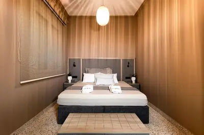 a bedroom with a large bed with two towels on it at Lefka Home in Rhodes Town