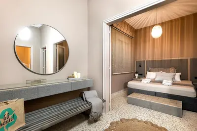 a bedroom with a bed and a mirror at Lefka Home in Rhodes Town
