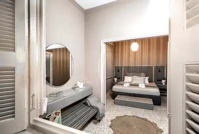 a bedroom with a bed and a mirror at Lefka Home in Rhodes Town