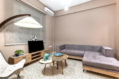 a living room with a couch and a tv at Lefka Home in Rhodes Town