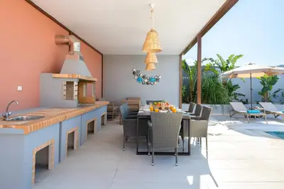 a kitchen and dining room with a table and chairs at Elias' Rest Villa in Pastida