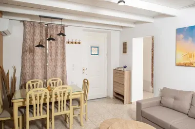 a living room with a table and chairs and a couch at Giannis House in Rhodes Town
