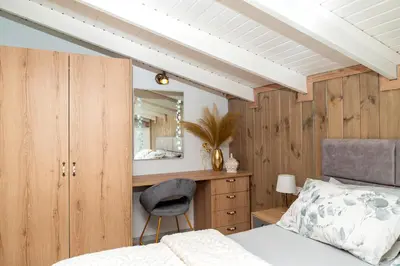 a bedroom with a bed and a mirror and a chair at Giannis House in Rhodes Town
